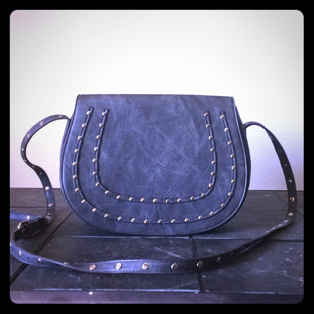Cross body studded bag with adjustable strap.